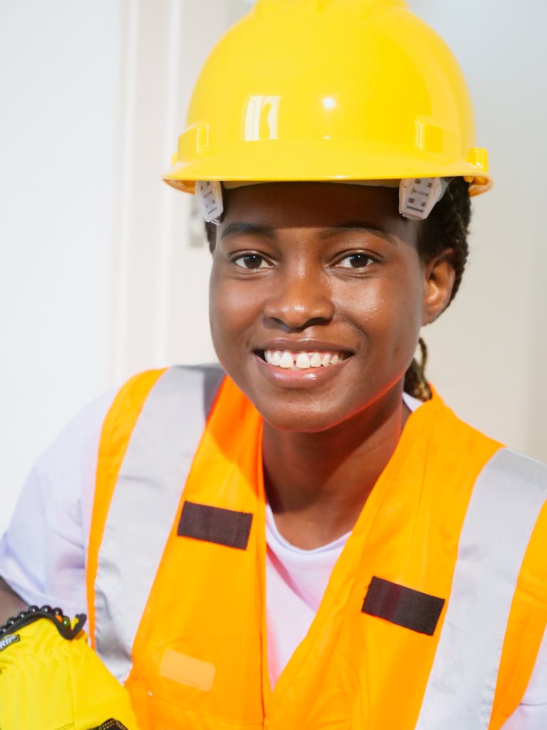 Confident African American female engineer wearing PPE at work site.