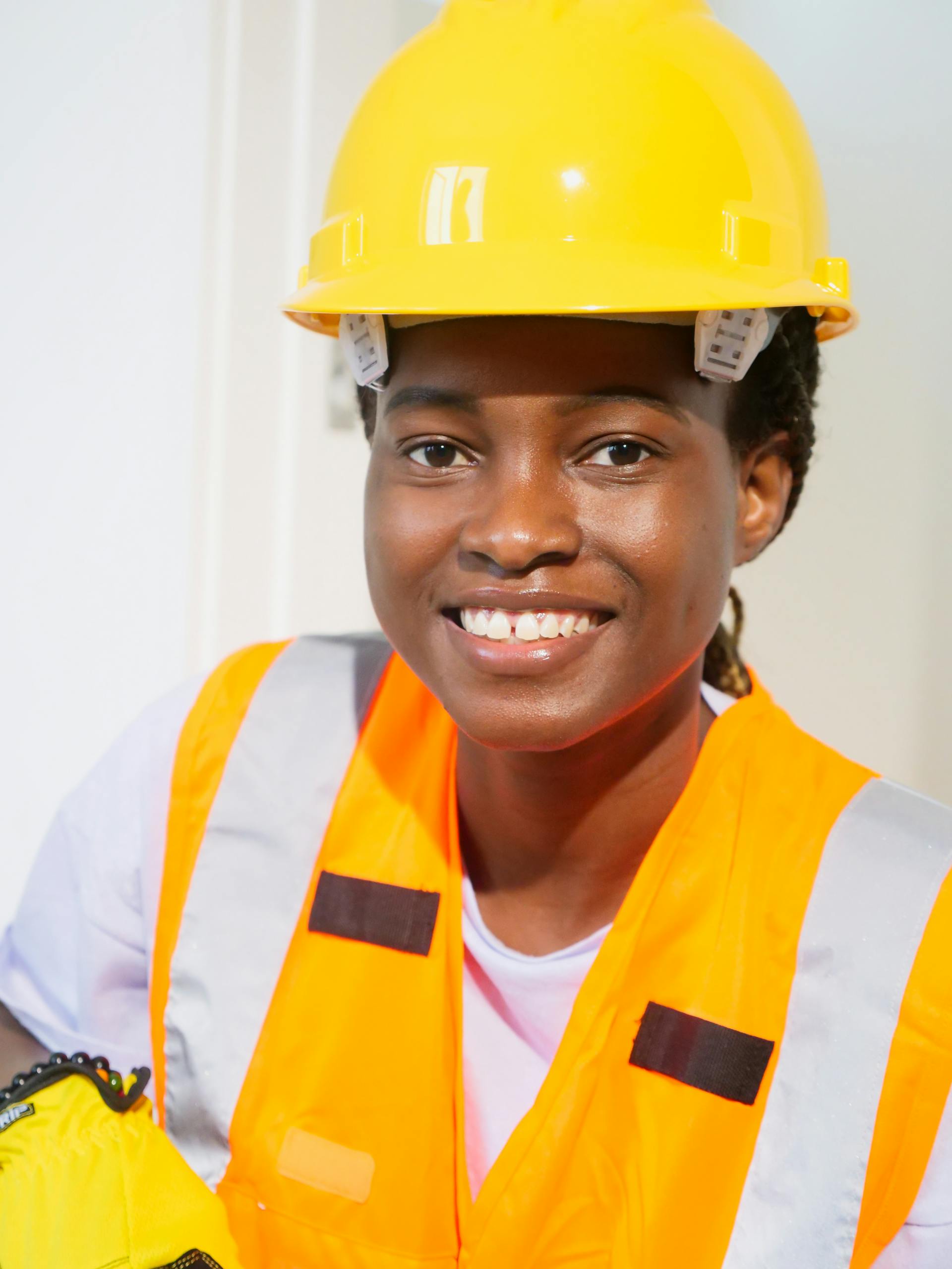 Confident African American female engineer wearing PPE at work site.